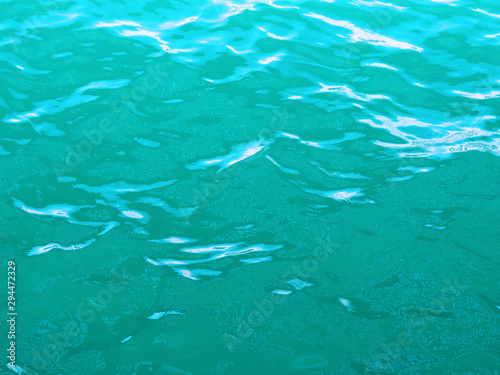 Water background, turquoise water during slight excitement