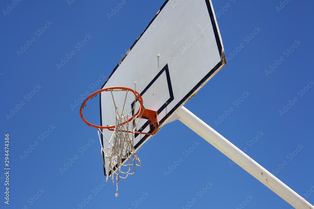 Outdoor basketball hoop against a blue sky - street basketball Outdoor basketball hoop against a blue sky - street basketball