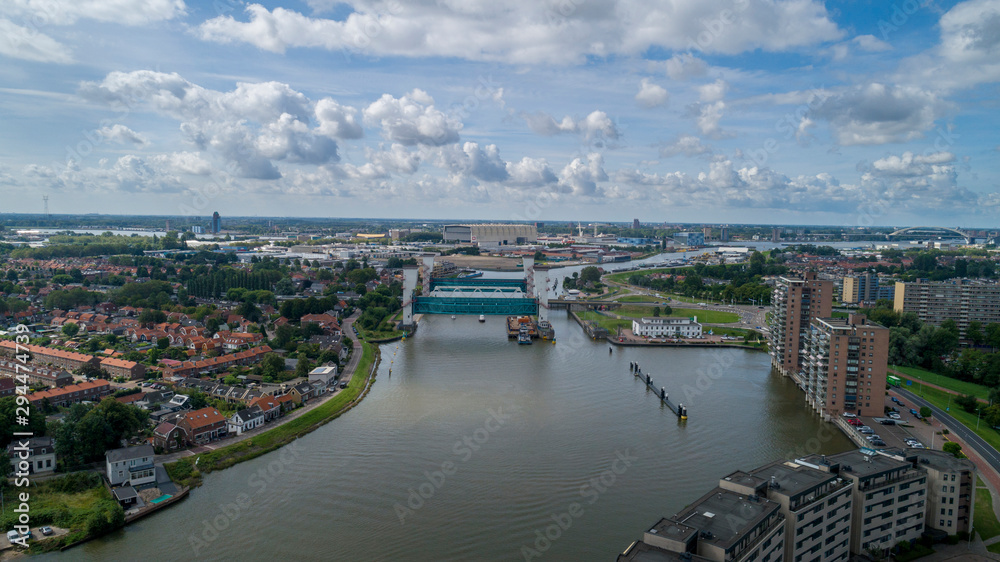 Fototapeta premium the lifted Algera flood barrier in the river Hollandse IJssel in the background on a sunny day in summertime
