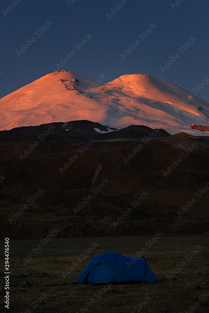 Tourist tent on the background of the snowy peaks of Mount Elbrus
