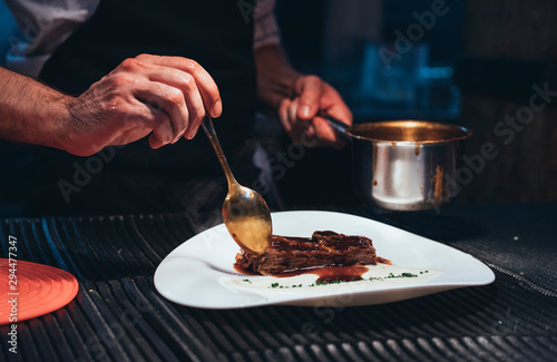 Fototapeta Naklejka Na Ścianę i Meble -  Professional chef serving food on plates