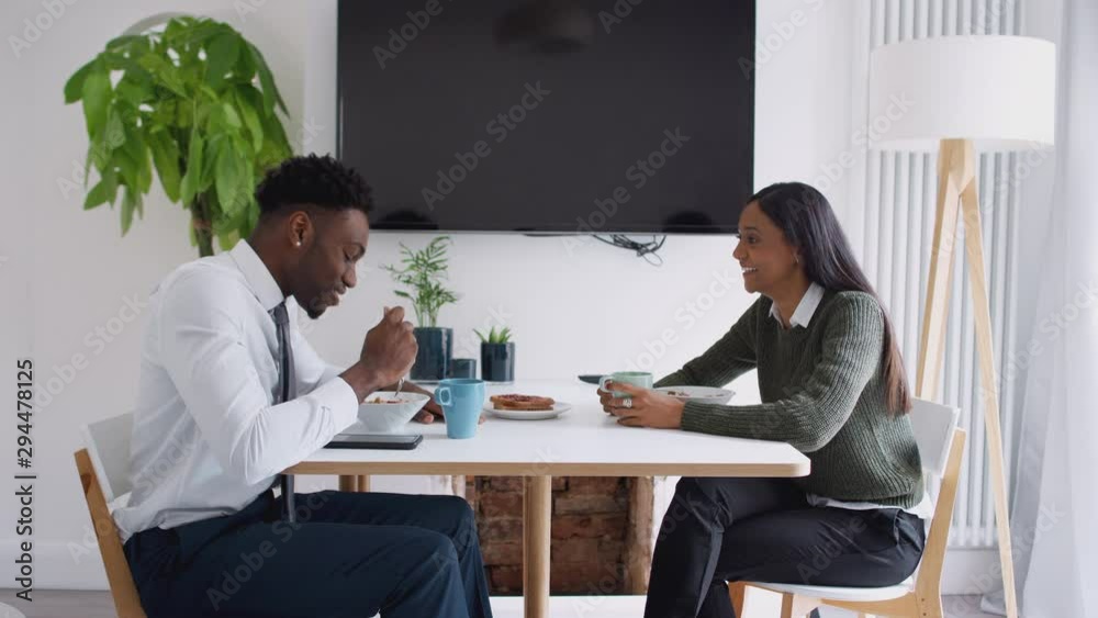 Business Couple At Home Eating Breakfast Before Leaving For Work Business Couple At Home Eating Breakfast Before Leaving For Work