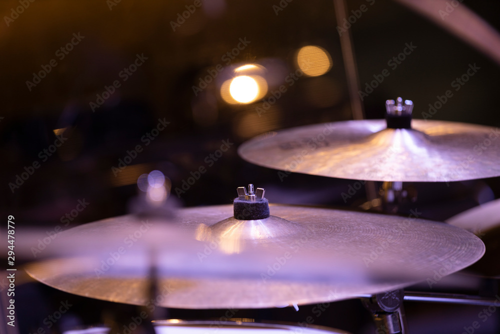 Fototapeta premium Two crash cymbals of a drumset in stage lighting