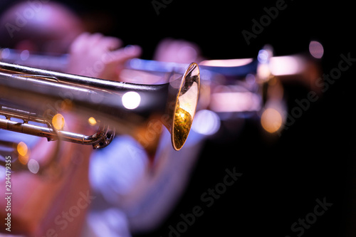 Canvas Print One lacquered trumpet in focus out a big band trumpet section