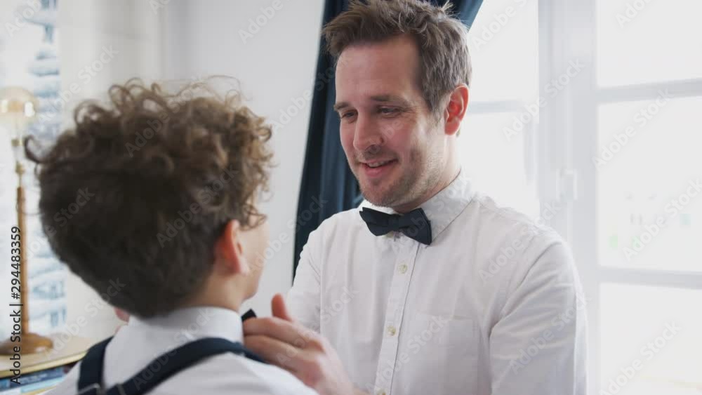 Father And Son Wearing Matching Outfits Getting Ready For Wedding At Home Father And Son Wearing Matching Outfits Getting Ready For Wedding At Home