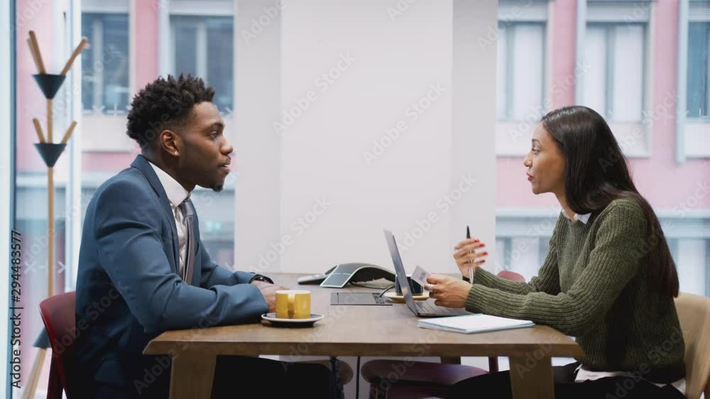 Businesswoman Interviewing Male Job Candidate In Meeting Room Businesswoman Interviewing Male Job Candidate In Meeting Room