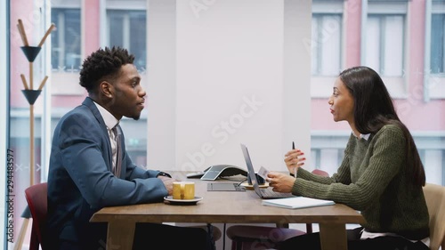Businesswoman Interviewing Male Job Candidate In Meeting Room