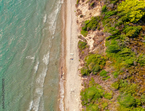 Paradise sunny tropical beach above aerial drone view. Wave on beach from above Drone photography. Wild beach on pacific ocean above view from drone.
