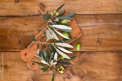 Olives with table. Wooden table with olive trees. Free space for text.