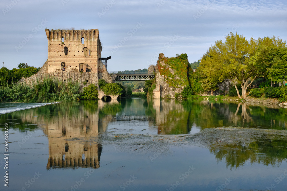 View of the medieval bridge reflected in the river of Mincio in orghetto sul Mincio