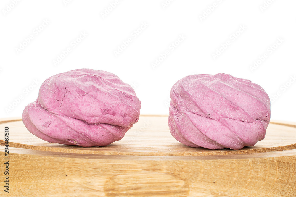 Group of two whole rose fresh pastel zefir on bamboo plate isolated on white background Group of two whole rose fresh pastel zefir on bamboo plate isolated on white background