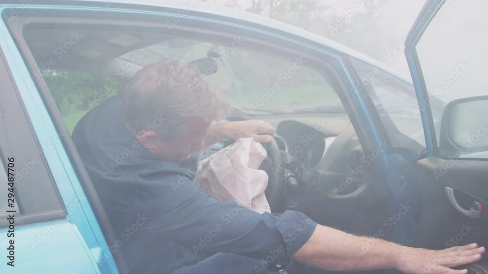 Male Motorist Injured In Car Crash With Airbag Deployed Getting Out Of