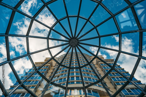 Looking up at modern building through glass transparent dome