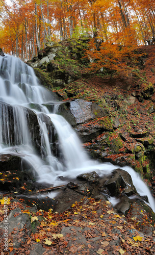 Mountain waterfall in autumn forest