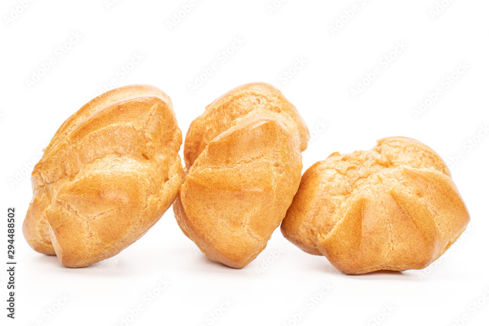 Group of three whole baked golden profiterole in line isolated on white background