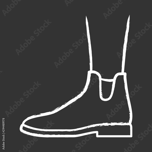 Women ankle boots chalk icon. Chelsea trendy shoes side view. Female flat heel footwear design for fall and spring season. Apparel, ladies clothing accessory. Isolated vector chalkboard illustration