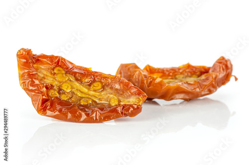 Group of two slices of dry red cherry tomato isolated on white background