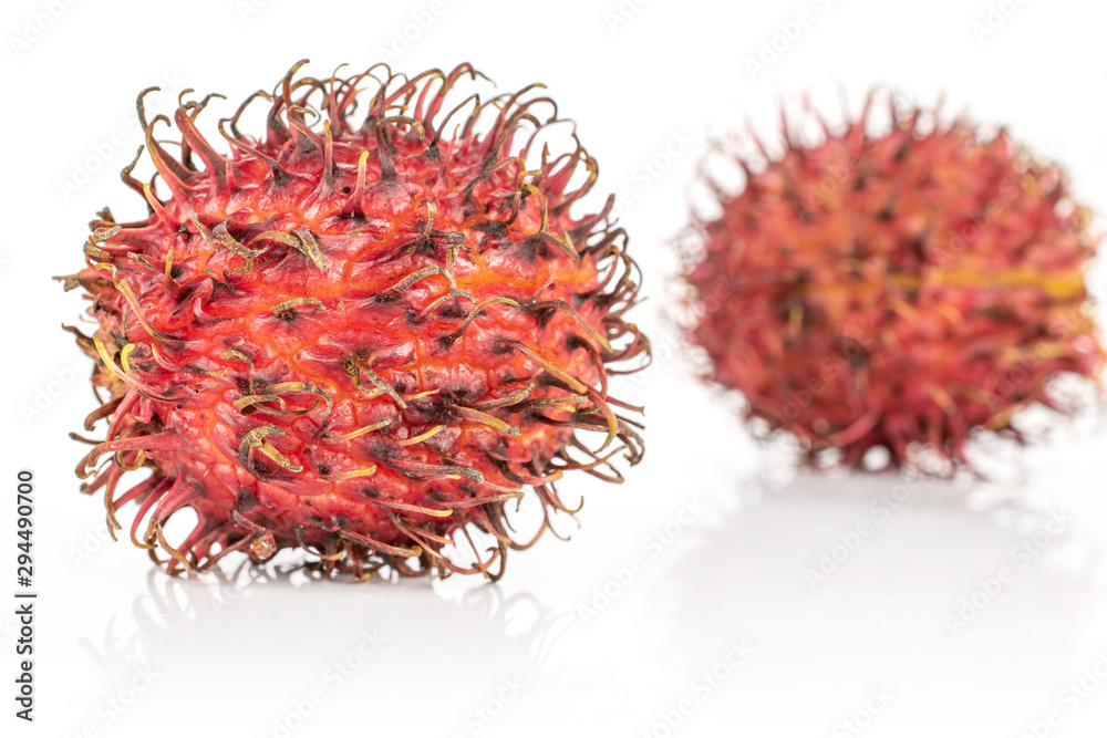Group of two whole fresh red rambutan isolated on white background Group of two whole fresh red rambutan isolated on white background