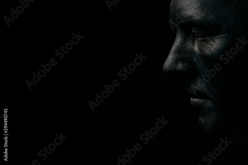Makeup portrait of a young man with black face, close-up