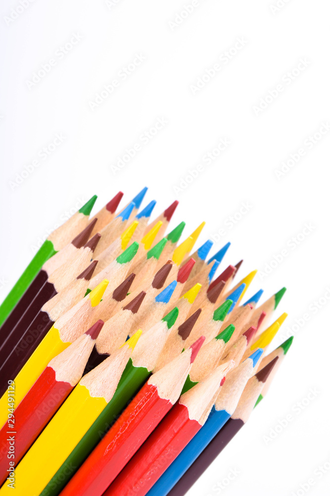 Fototapeta premium Many different colored pencils on a white background with a place for text and cory space .