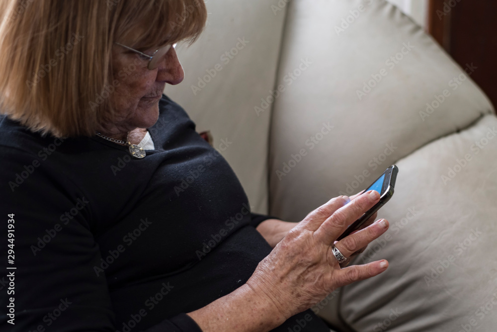 elderly woman using her smartphone