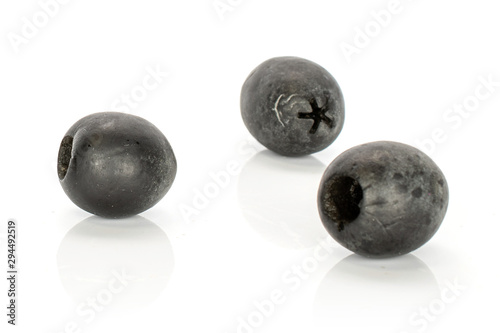Group of three whole tasty black olive isolated on white background