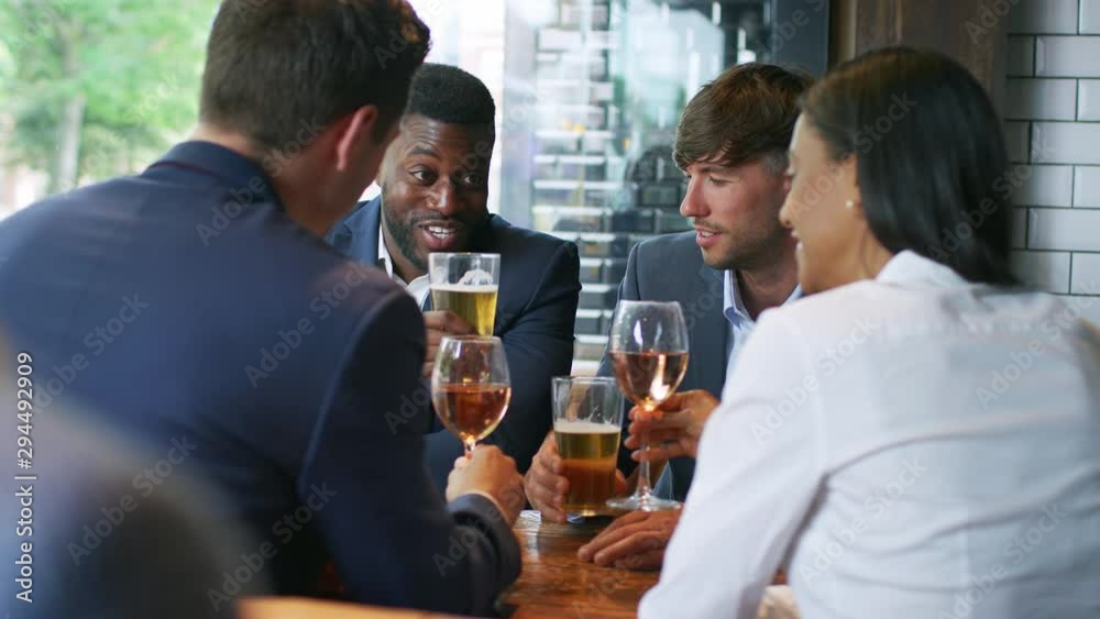 Group Of Business Colleagues Meeting For Drinks And Socializing In Bar After Work Group Of Business Colleagues Meeting For Drinks And Socializing In Bar After Work