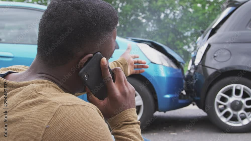 Male Driver Involved In Car Accident Calling Insurance Company From Roadside