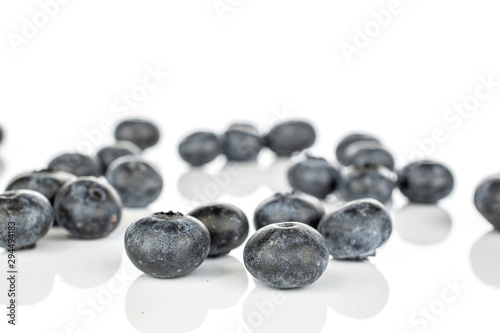 Lot of whole disordered fresh blue blueberry isolated on white background