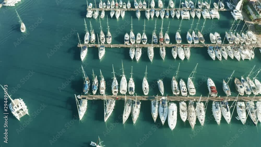 Aerial down view of docked sailing yachts and catamarans in marina Aerial down view of docked sailing yachts and catamarans in marina