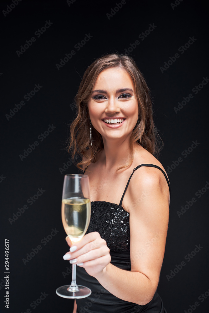 Young happy woman in elegant dress with glass of champagne at party. Young happy woman in elegant dress with glass of champagne at party.