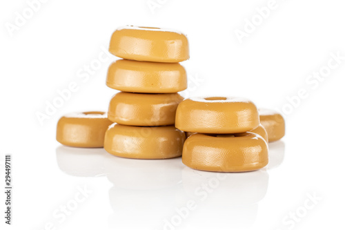 Lot of whole arranged caramel brown candy heap isolated on white background