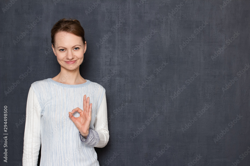 Portrait of happy girl showing ok gesture, being satisfied Portrait of happy girl showing ok gesture, being satisfied