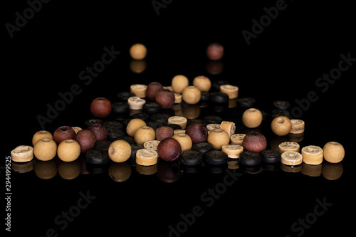 Lot of whole wooden bead stack isolated on black glass