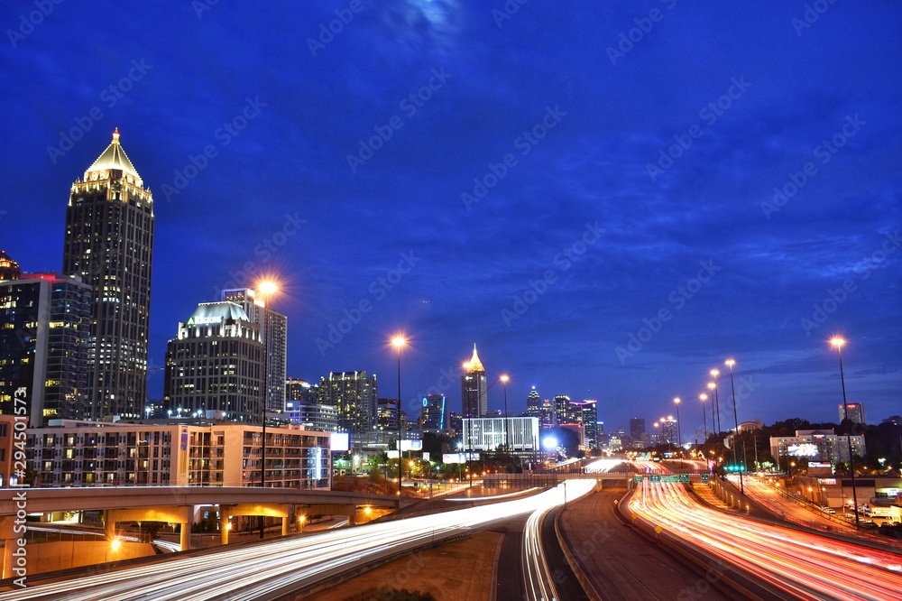 Midtown Atlanta interstate highway with light trails and a blue evening sky