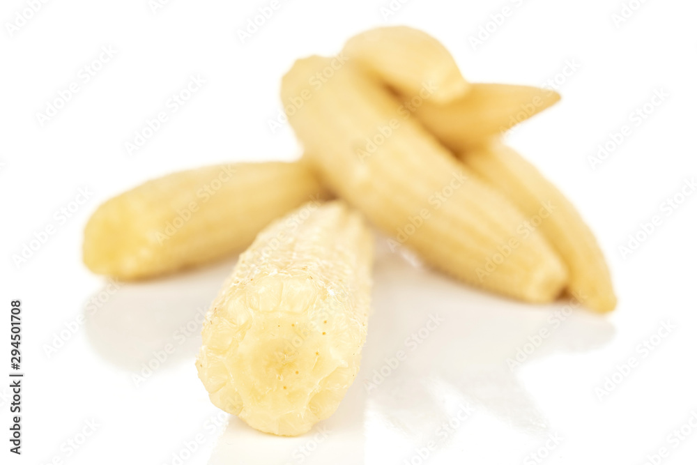 Group of five whole disordered baby yellow corn isolated on white background