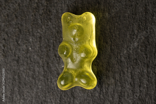 One whole gummy bear flatlay on grey stone