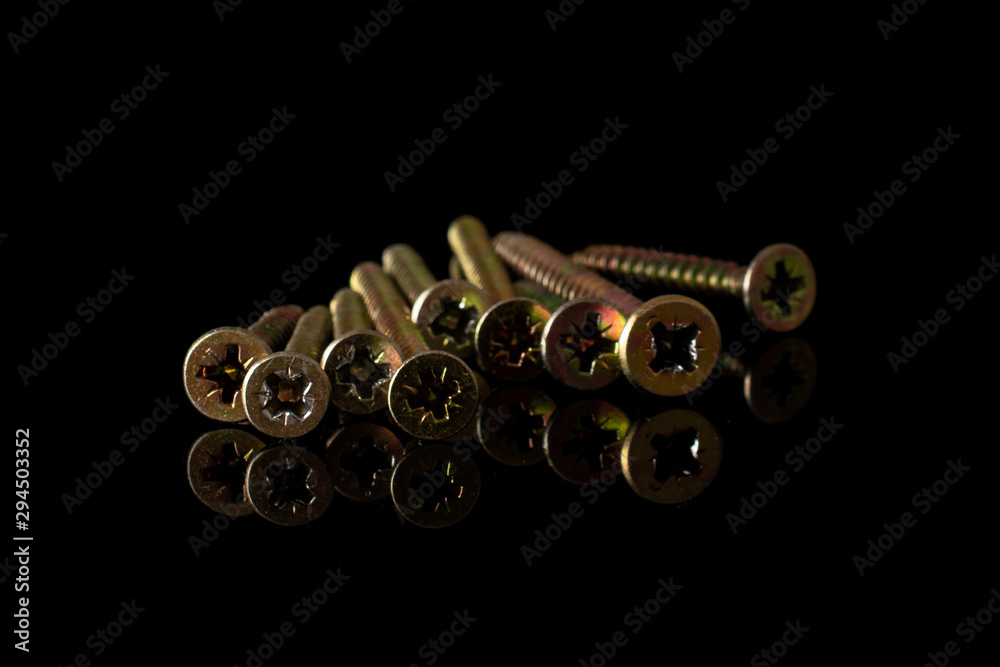 Group of nine whole metallic glossy bolt isolated on black glass Group of nine whole metallic glossy bolt isolated on black glass