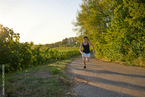 jogger Runner jogging young attractive shorts vineyards sportsman sunset greenery nature sprint