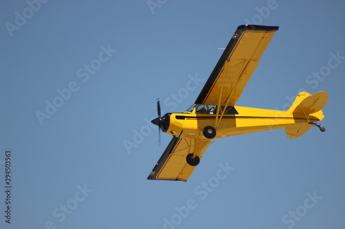 airplane with propeller flying in blue sky  photo