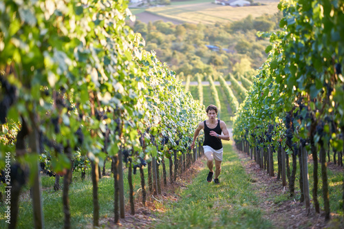 jogger running uphill in beautiful nature with view
