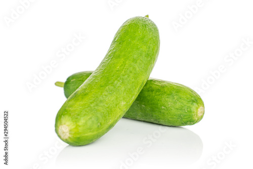 Group of two whole mini green cucumber isolated on white background