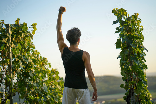 sporty man succeeded rising one arm winner photo