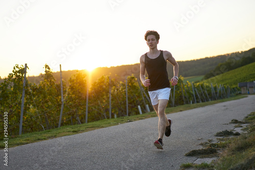 runner in shorts during sunset