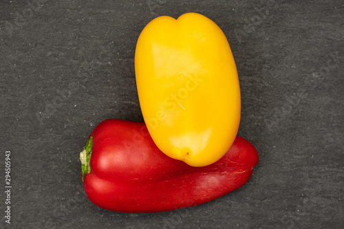 Group of two whole fresh pepper flatlay on grey stone photo