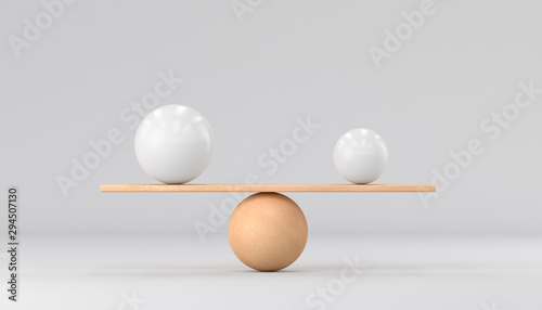 Fotografia Wooden scales and two spheres on a white background