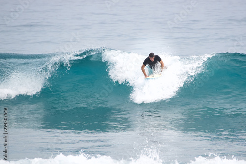 Surfer pop up on a surfboard. Atlantic Ocean...