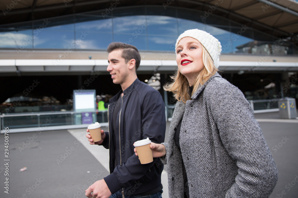 Man and Woman Walking Past Southern Cross Station Man and Woman Walking Past Southern Cross Station