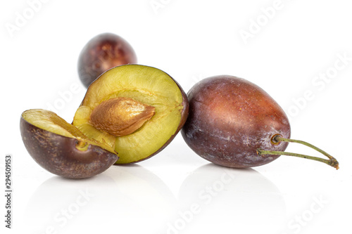 Group of two whole one half of sweet purple plum isolated on white background