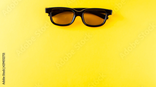 3D black glasses on yellow background
